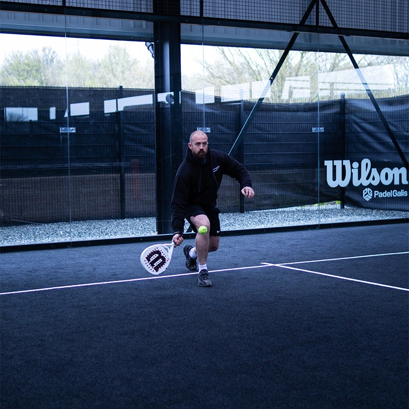 Player under hand hit with padel racket